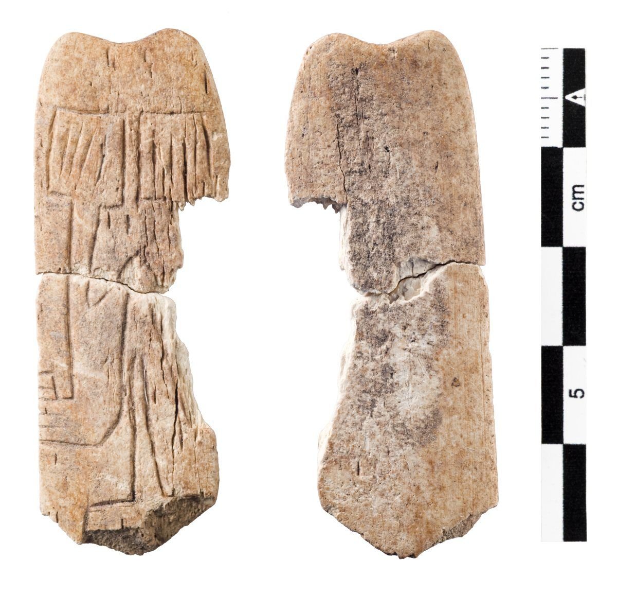 A small decorated bone 'spatula' from Göbekli Tepe. The worn carving may be an abbreviated depiction of the site's own T-pillars — a possible monument-in-miniature rendered in two dimensions. The reading is tentative. Now in the Şanlıurfa Museum.