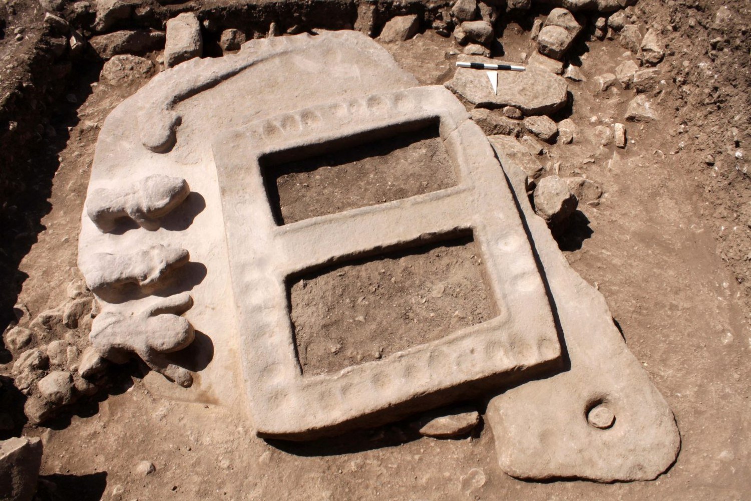 A decorated porthole slab from Göbekli Tepe, pierced with an opening and carved in relief