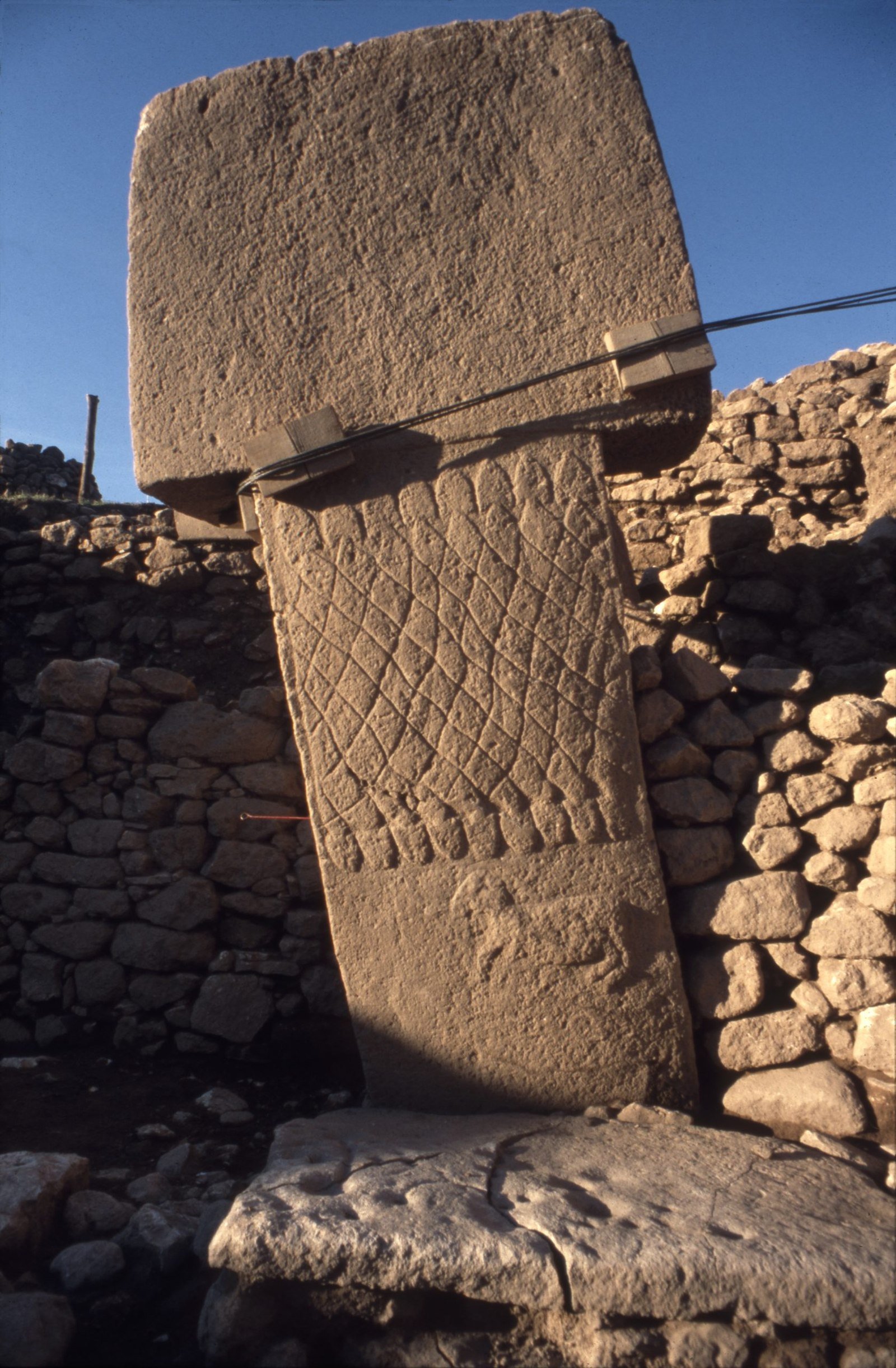 Central Pillar 1 of Enclosure A, an anthropomorphic T-pillar carved with a snake-net, a belt and a ram