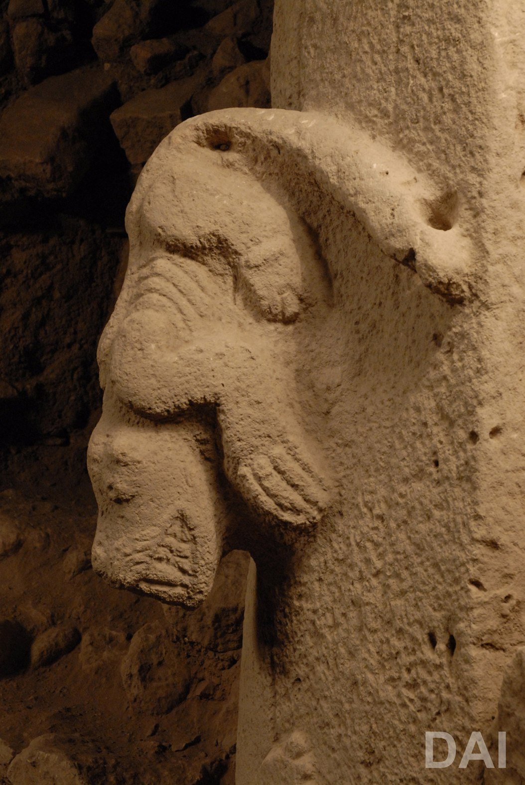 Close view of the Pillar 27 predator, its head, forelimbs and paws standing well clear of the pillar face in high relief
