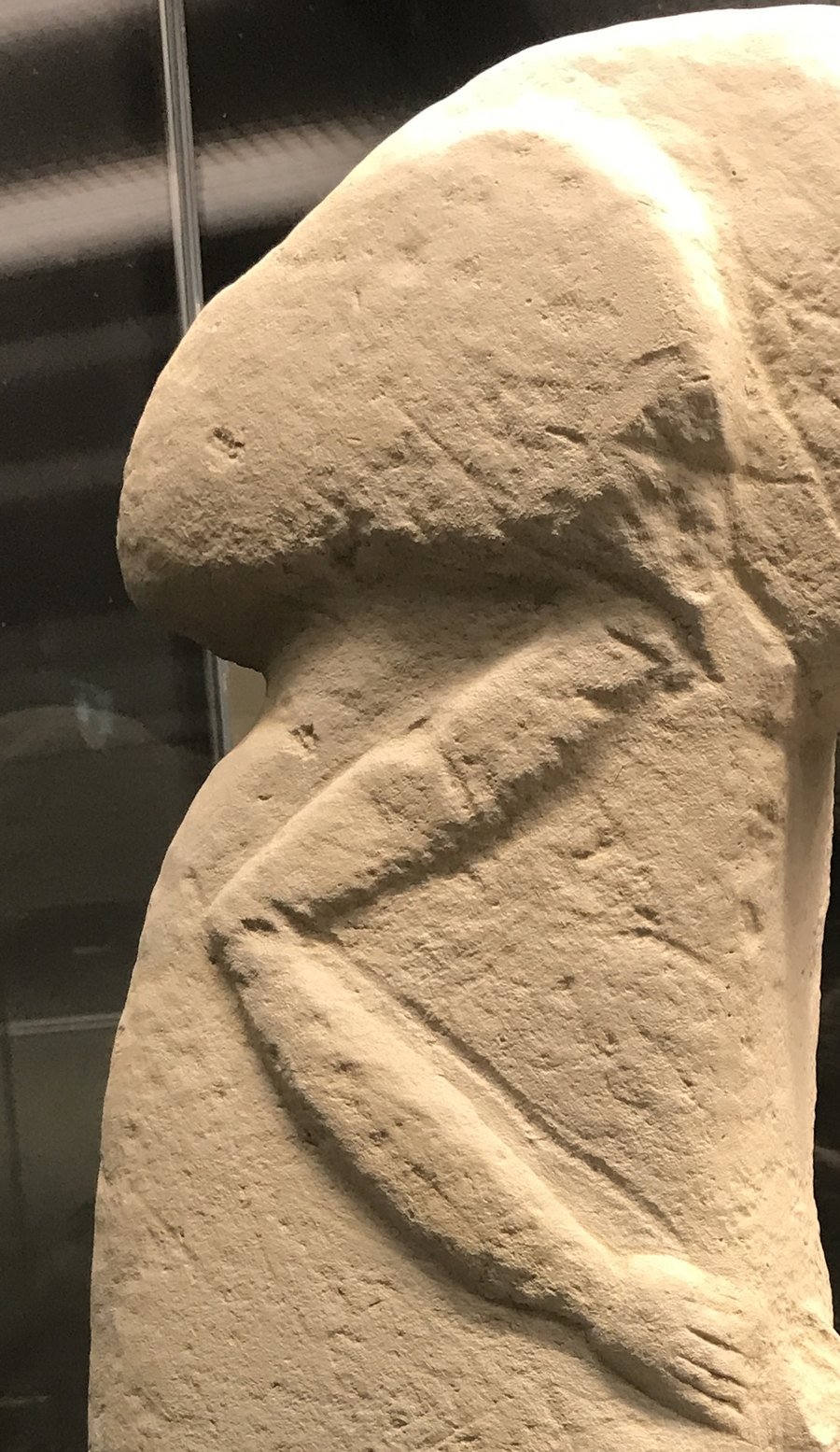 Detail of the Kilisik figure: the broad T-shaped head, and the arm bent sharply down the side to meet the hands at the belly — the same gesture carved on Göbekli Tepe's central pillars.
