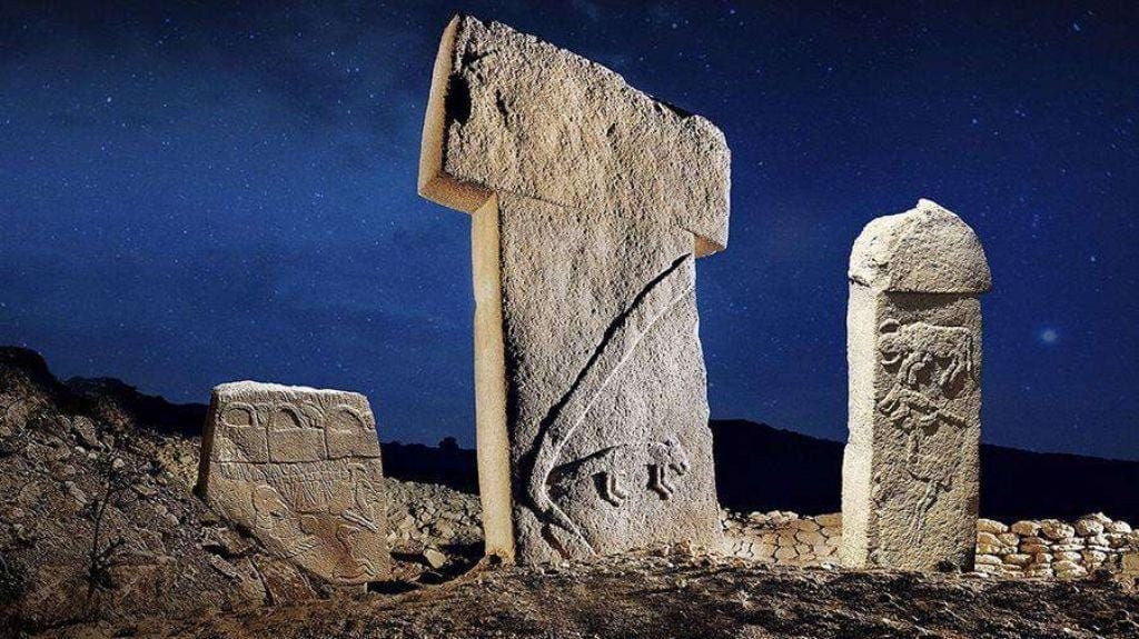 Göbekli Tepe's pillars under a night sky. The romance of the idea — a Stone-Age observatory reading the heavens — is a large part of why the 'star map' theory spread so far.