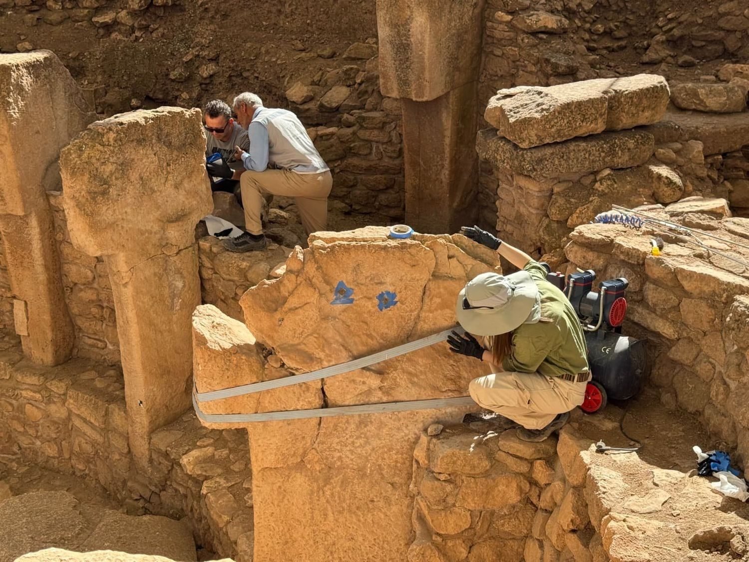 An archaeologist working on a strapped and braced T-pillar during the 2026 conservation campaign at Göbekli Tepe.