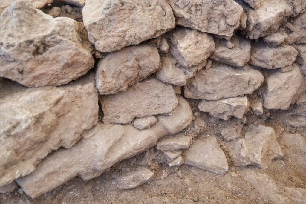 The figure was embedded horizontally in the chamber wall — a placement the excavators read as deliberate, likely part of a ritual act.