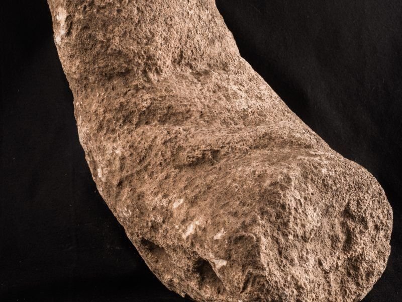 A larger seated limestone sculpture from Göbekli Tepe. Seated figures like this belong to the site's inventory of portable and human imagery, distinct from the fixed T-pillars.